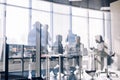 Side view of blurred silhouettes of businessmen talking in conference room