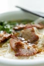 bowl of bbq prok with rice noodles vertical composition