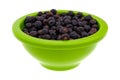 Side view of a bowl filled with juniper berries Royalty Free Stock Photo