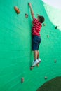 Side view of boy climbing wall at playground Royalty Free Stock Photo