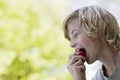 Side View Of Boy Eating Apple Outdoors Royalty Free Stock Photo