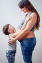 Side view of boy hugging pregnant mom Royalty Free Stock Photo