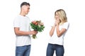 side view of boyfriend presenting bouquet to surprised girlfriend