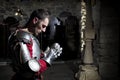 Side View Of Knight Kneeling On His Knees With Bowed Head And Praying Hands Royalty Free Stock Photo