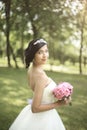 Side view. bride with bouquet standing in the Park