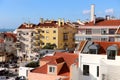 Side view of the bright old residential buildings with orange tiled roofs against the blue sky. Royalty Free Stock Photo