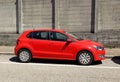 Side view of bright red Volkswagen Polo