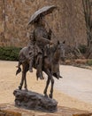Side view of a bronze sculpture titled `Honeymoon at Crow Fair` by John Coleman in Edmond, Oklahoma.