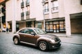 Side View Of Brown Volkswagen New Beetle Hatchback Coupe Car In