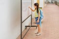 Side view of brunette child in school writing on school board. Royalty Free Stock Photo