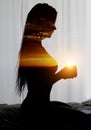 Side view brunette woman sit on bed holding coffee cup photo digitally altered combined with double exposure glowing sun Royalty Free Stock Photo