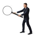 Side view of a businessman holding big magnifier with both hands isolated on white background Royalty Free Stock Photo