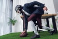 side view of businessman in rugby helmet playing american football