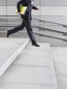 Side View Of Businessman Running Down Steps Royalty Free Stock Photo