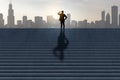 Side view of businessman silhouette looking into the distance on stairs with shadow and city skyline in the background. Success,