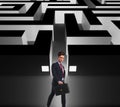 Side view of a businessman walking by a maze