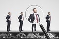 Businessmen on conveyor, magnifying glass Royalty Free Stock Photo