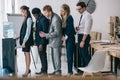 side view of businesspeople standing in queue for water dispenser Royalty Free Stock Photo