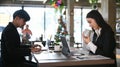 Side view of businesspeople working together at desk in office. Royalty Free Stock Photo