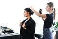 side view of businesswoman getting hairstyle fixated with hair spray