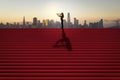 Side view of businesswoman silhouette with telescope looking into the distance on red stairs with shadow and city skyline in the