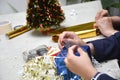 Side view Busy Woman s hands wrapping christmas gift, close up, unprepared chistmas presents on cement table at indoors home park