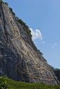 Side view of carved buddha image on the cliff