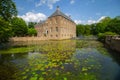 Side view from Castle Arcen reflective in water with lelies Royalty Free Stock Photo