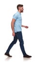 Side view of casual man in blue polo shirt walking Royalty Free Stock Photo