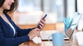 Casual woman using laptop and smart phone in coffee shop. Royalty Free Stock Photo