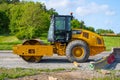 Side view of a Caterpillar CS66B vibratory soil compactor..