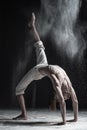 Side view of caucaisanl young man working out, doing yoga or pilates exercise. Bridge pose, Urdhva Dhanurasana.