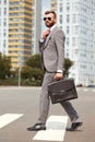 Side view on caucasian businessman walking with bag Royalty Free Stock Photo