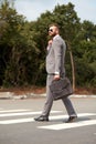 Side view on caucasian businessman walking with bag Royalty Free Stock Photo