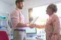 Male doctor interacting with female senior patient in clinic Royalty Free Stock Photo