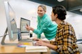 Male and female graphic designer discussing over computer Royalty Free Stock Photo