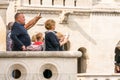 Side view of a caucasian male and female tourist standing at a viewpoint outside and below Matthias Church in Budapest. Royalty Free Stock Photo