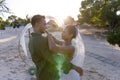 Side view of caucasian newlywed couple dancing at wedding ceremony at beach during sunset Royalty Free Stock Photo