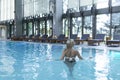 Side view of a Caucasian woman resting at poolside. She is enjoying a quiet weekend at the spa