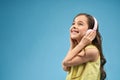 Side view of cheerful girl in headphones listening music Royalty Free Stock Photo