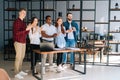 Side view of cheerful group of multi-ethnic business people applauding and smiling gratefully Royalty Free Stock Photo