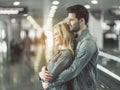 Beaming man embracing outgoing female