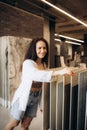 Side view of a cheerful young woman smiling while choosing new floor tiles for her home at the tile shop Royalty Free Stock Photo