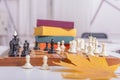 Side view of a chessboard with white and black pieces. The game has begun, the first moves have been made. Royalty Free Stock Photo
