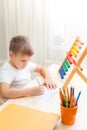 Side view of child solving maths exercises Royalty Free Stock Photo