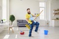 Funny clean home. Positive man with cleaning broom.