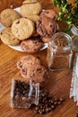 Side view of chocolate chip cookies on a wooden plate over rustic background, selective focus Royalty Free Stock Photo