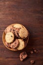 Side view of chocolate chip cookies on a wooden plate over rustic background, selective focus Royalty Free Stock Photo