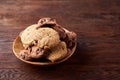 Side view of chocolate chip cookies on a wooden plate over rustic background, selective focus Royalty Free Stock Photo