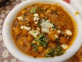 Side view Chola Chana Chaat, Bowl of Chickpeas curry or Chola masala. Ramadan Iftari Dinner. Ramzan Meal. Royalty Free Stock Photo